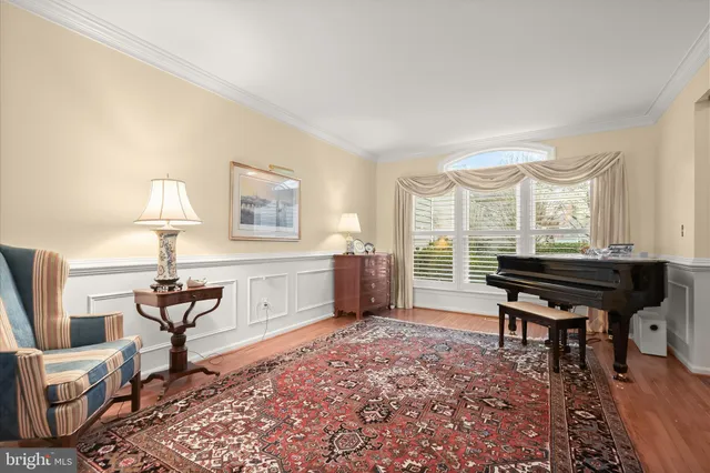 a living room with furniture a window and a piano