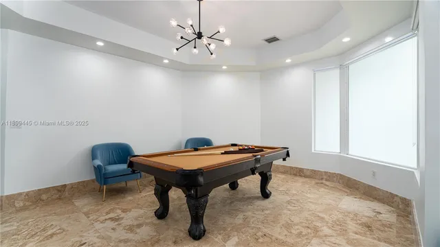 a room with furniture and chandelier