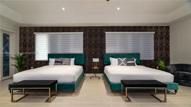 a bedroom with two beds and a table