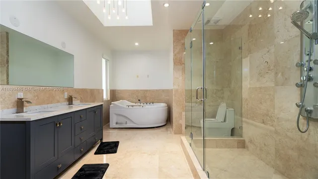 a bathroom with a double vanity sink mirror and shower