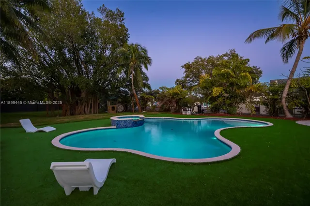 a view of a swimming pool with a yard