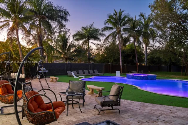 a view of swimming pool with outdoor seating