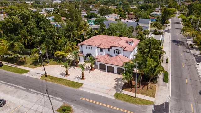 an aerial view of a house with a swimming pool