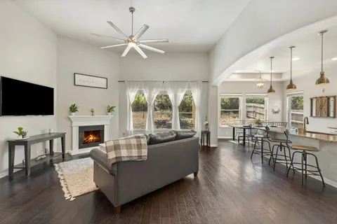 a living room with fireplace furniture and a flat screen tv