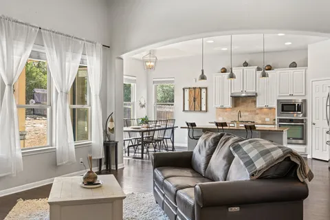 a living room with furniture and a large window