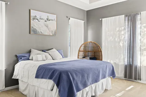 a bedroom with a bed and a painting on the wall