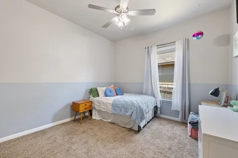 a bedroom with a bed and a chandelier