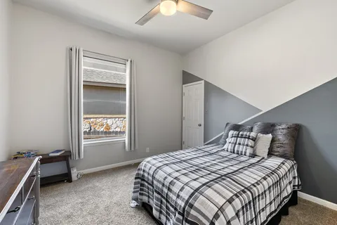 a bedroom with a bed and a chandelier