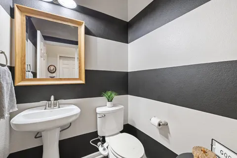 a bathroom with a sink a mirror and a toilet