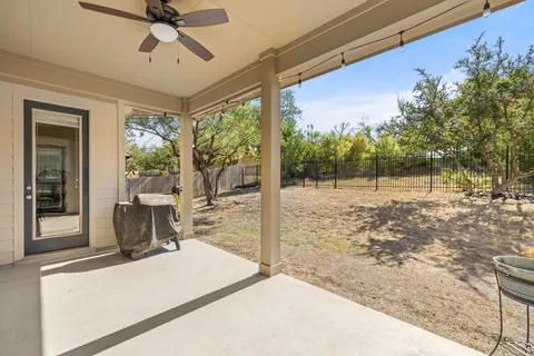 a view of a porch with furniture and a yard