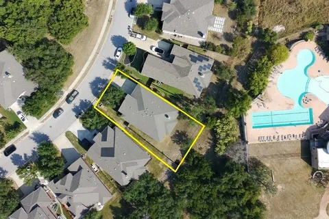 an aerial view of a house with a yard