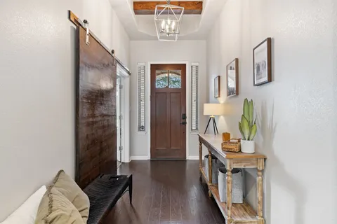 a view of an entryway with wooden floor