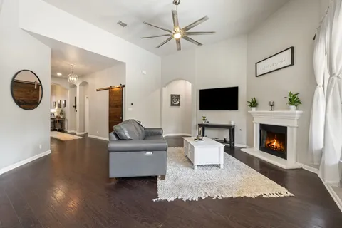 a living room with furniture a fireplace and a flat screen tv