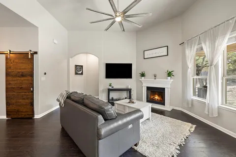 a living room with furniture a fireplace and a flat screen tv