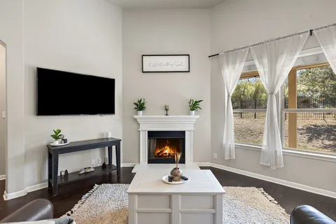 a living room with furniture fireplace and flat screen tv