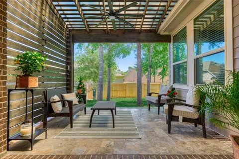 a view of a porch with chairs and potted plants
