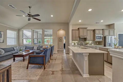 a large kitchen with a table and chairs