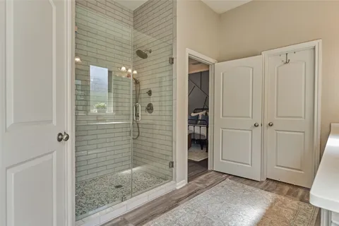 a bathroom with a tub a double vanity sink and mirror