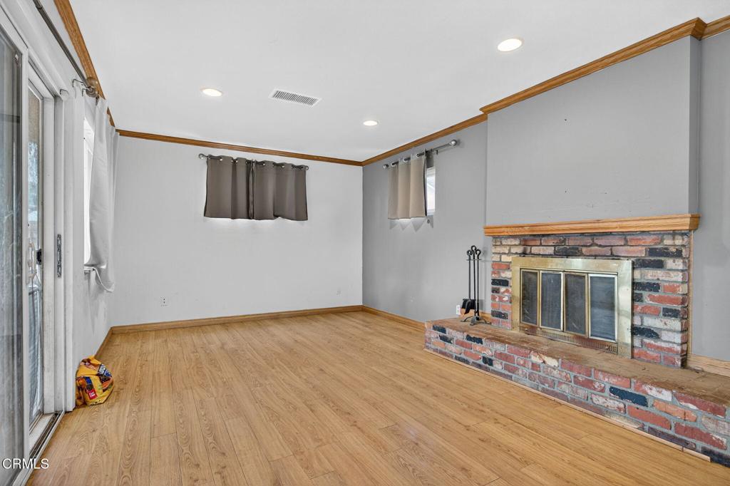 4105 South J Street Oxnard, CA 93033 - Photo 14 of 26 a view of livingroom with floor to ceiling window and fireplace