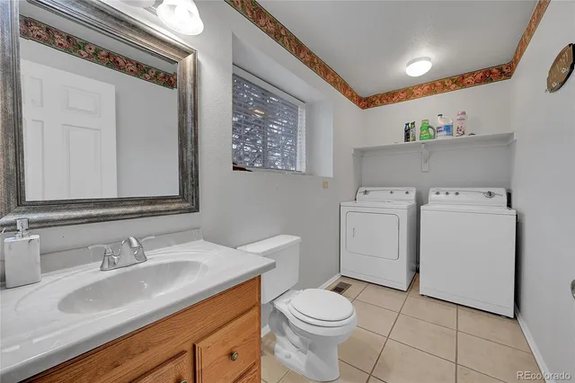 a bathroom with a sink toilet and vanity
