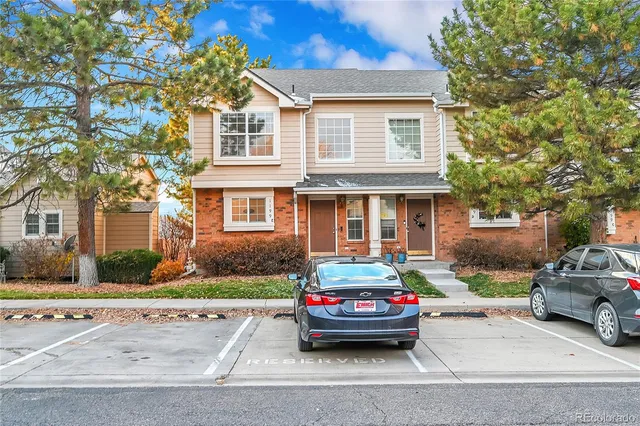 a car parked in front of a brick house