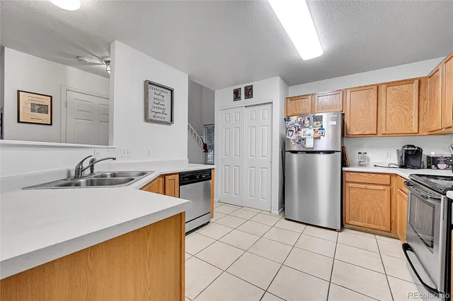 a kitchen with stainless steel appliances granite countertop a refrigerator and a sink