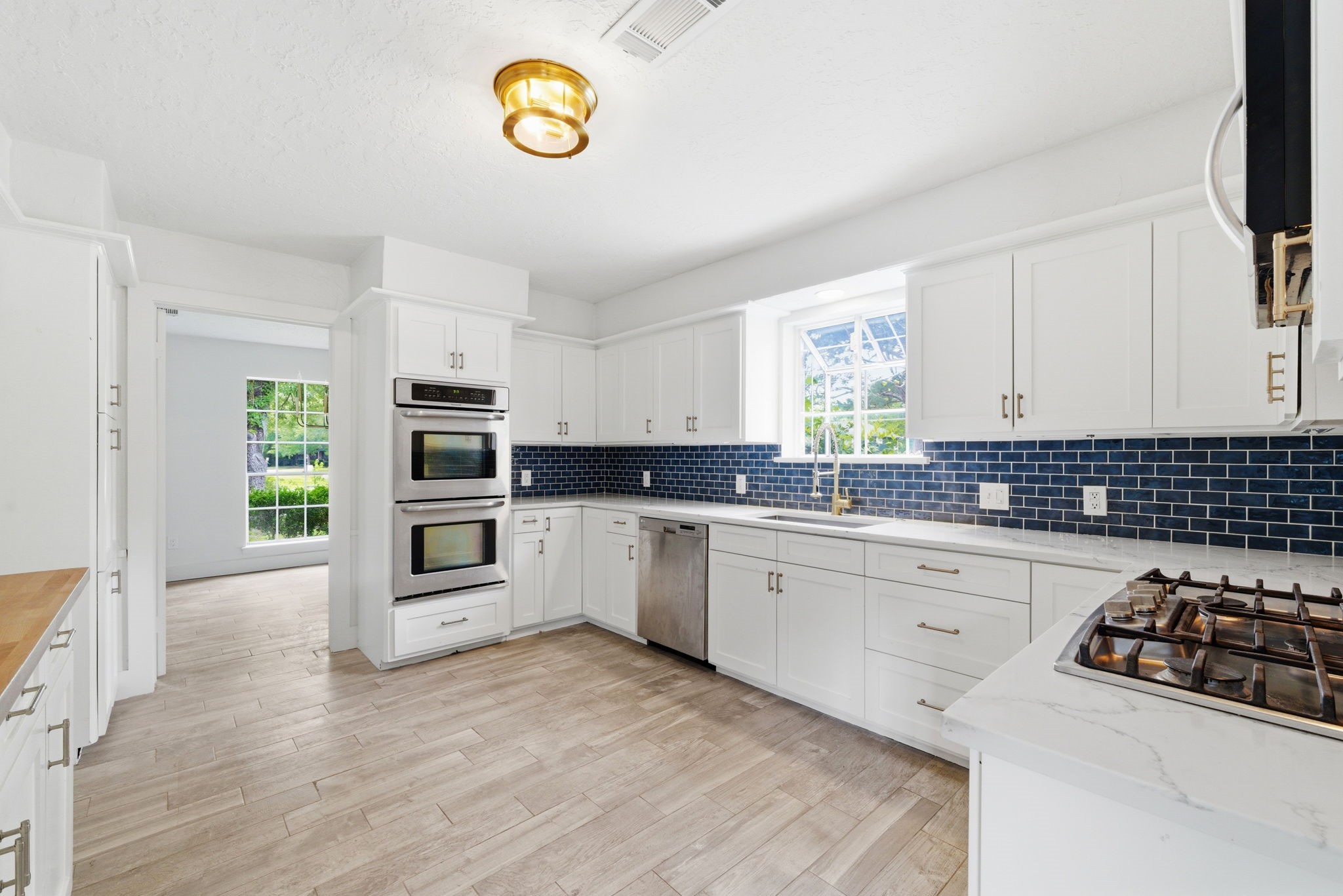8131 Theisswood Road Spring, TX 77379 - Photo 10 of 31 Double ovens and a gas cooktop