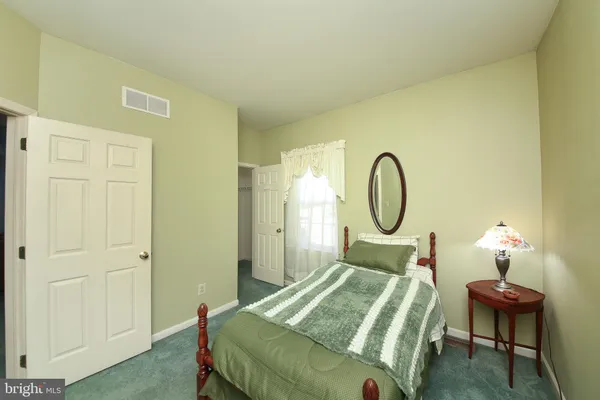 a bedroom with bed and a chandelier