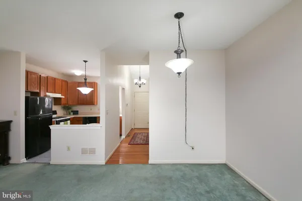 a view of a kitchen with a refrigerator and a sink