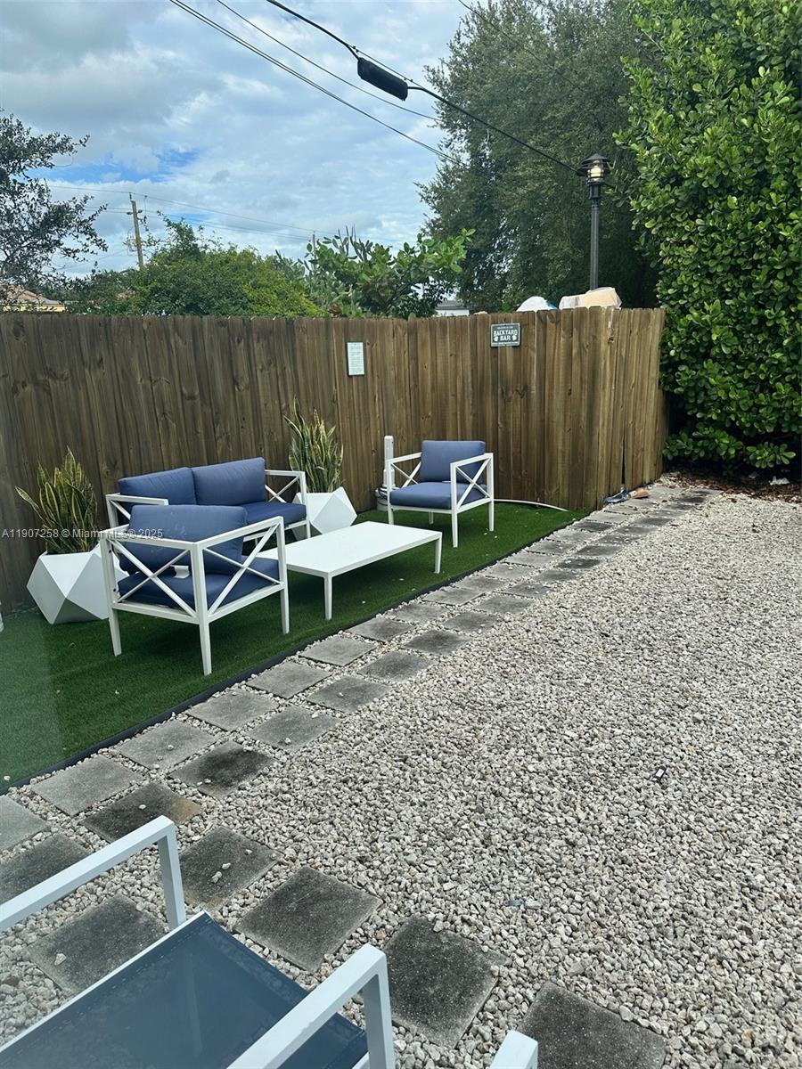 165 Northwest 39th Street, Unit 4 Miami, FL 33127 - Photo 9 of 11 a backyard of a house with table and chairs
