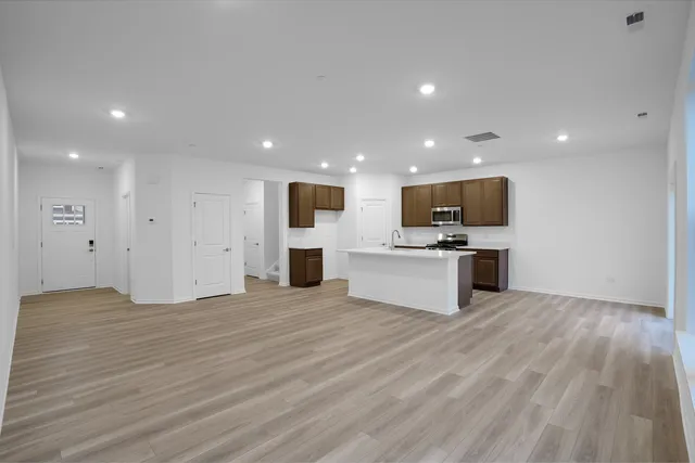 a view of kitchen with microwave oven a sink and white cabinets
