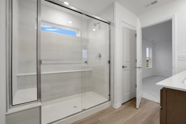 a bathroom with a glass shower door
