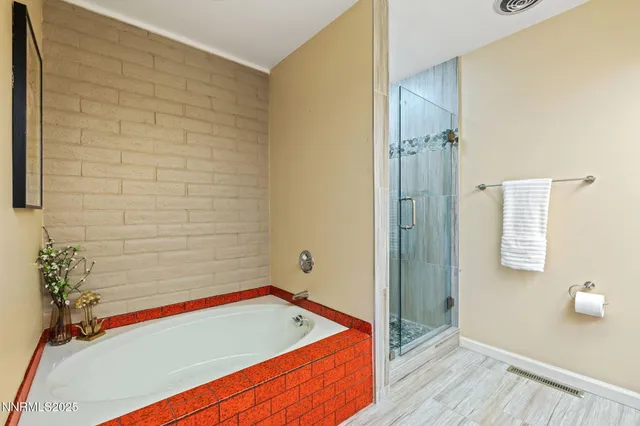 a bathroom with a tub and shower