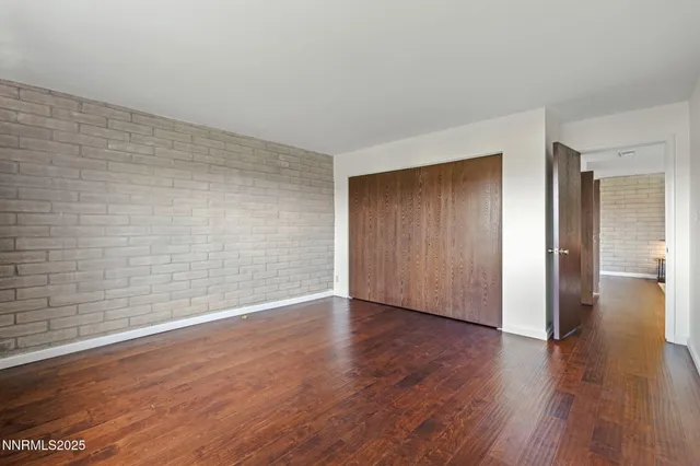 a view of an empty room and wooden floor