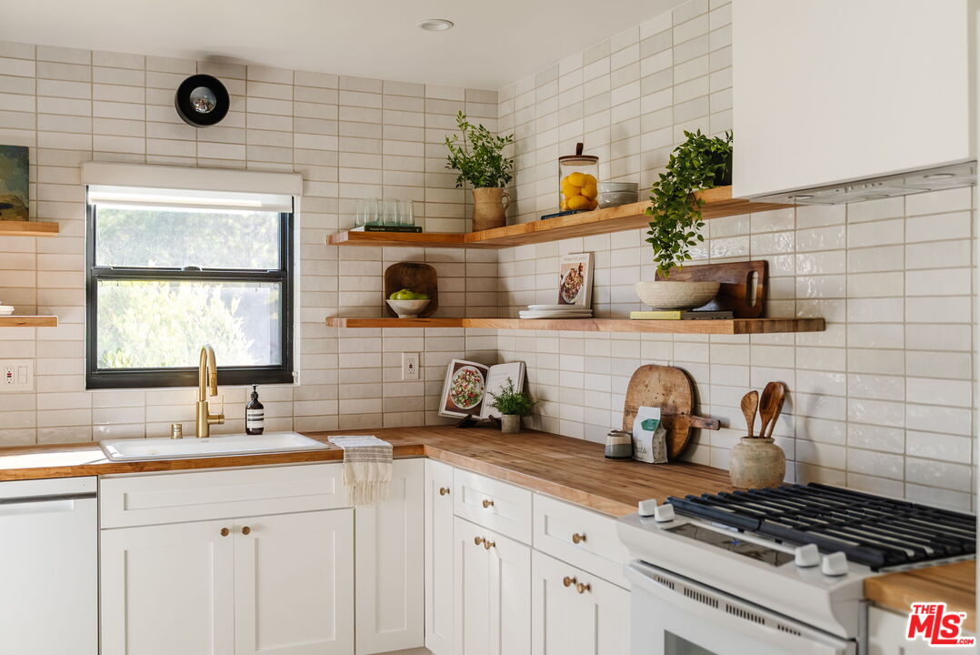 1943 12th, Unit B Santa Monica, CA 90404 - Photo 13 of 37 a kitchen with a stove a sink and cabinets