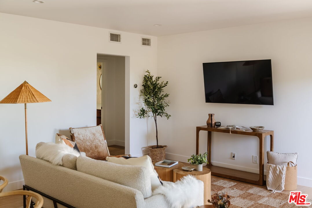 1943 12th, Unit B Santa Monica, CA 90404 - Photo 14 of 37 a living room with furniture and a flat screen tv