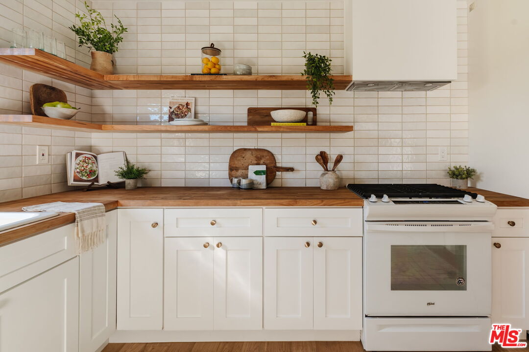 1943 12th, Unit B Santa Monica, CA 90404 - Photo 18 of 37 a kitchen with a stove and cabinets