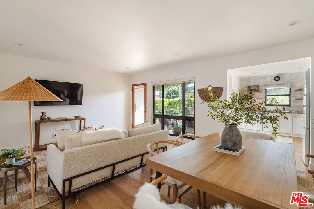1943 12th, Unit B Santa Monica, CA 90404 - Photo 2 of 37 a living room with furniture and a flat screen tv