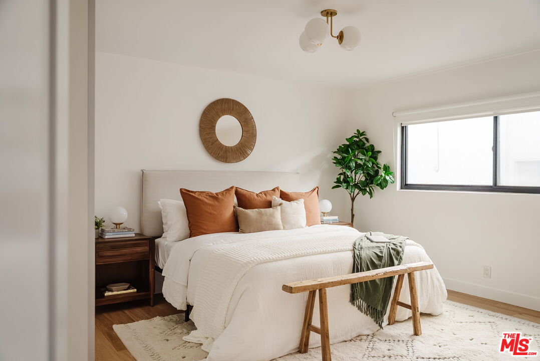 1943 12th, Unit B Santa Monica, CA 90404 - Photo 6 of 37 a bedroom with a bed and a potted plant
