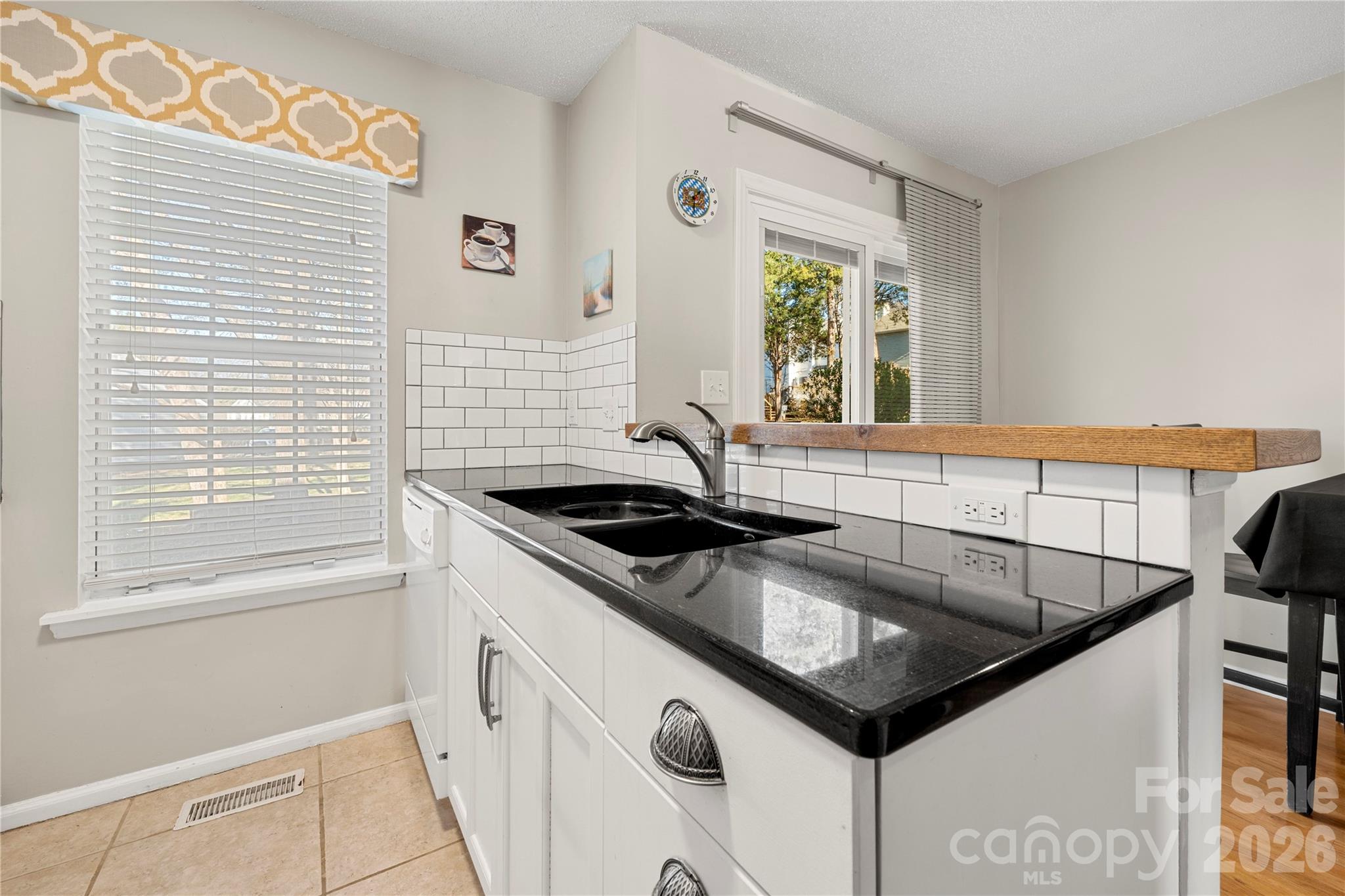8240 Circle Tree Lane Charlotte, NC 28277 - Photo 12 of 29 a kitchen with stainless steel appliances granite countertop a sink a stove and a window