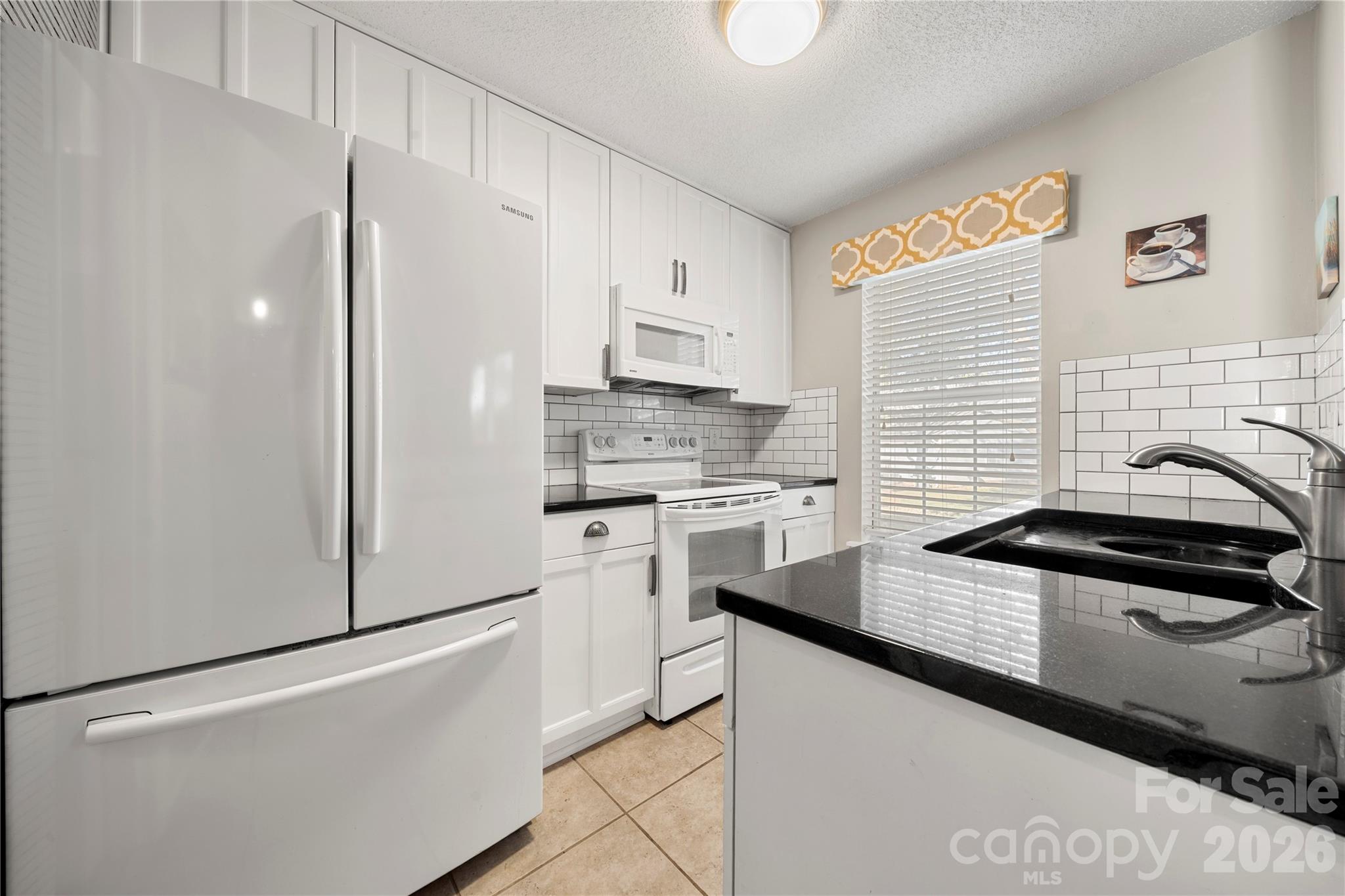 8240 Circle Tree Lane Charlotte, NC 28277 - Photo 13 of 29 a kitchen with stainless steel appliances granite countertop a sink stove and refrigerator
