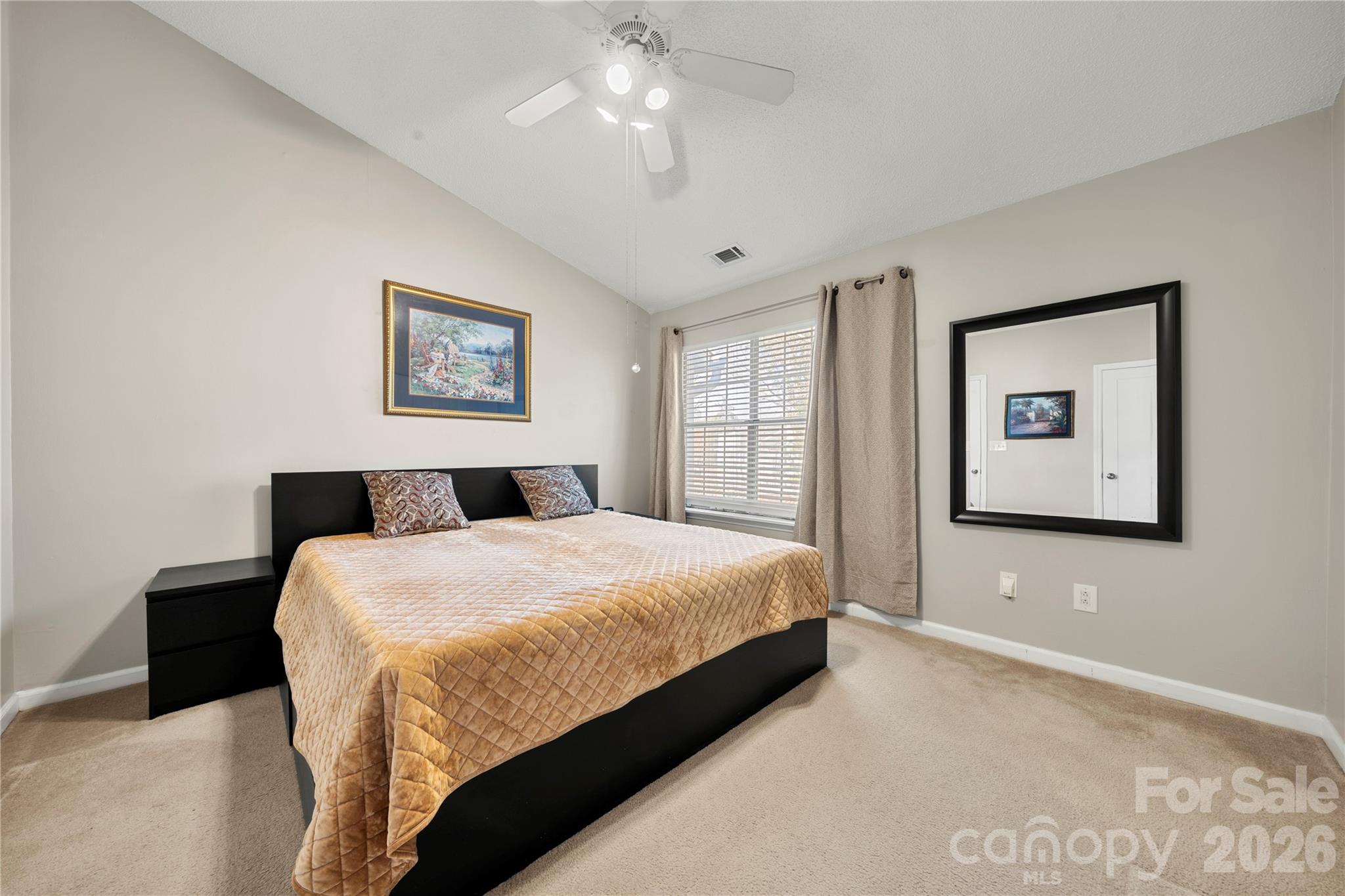 8240 Circle Tree Lane Charlotte, NC 28277 - Photo 16 of 29 a bedroom with a bed and a chandelier