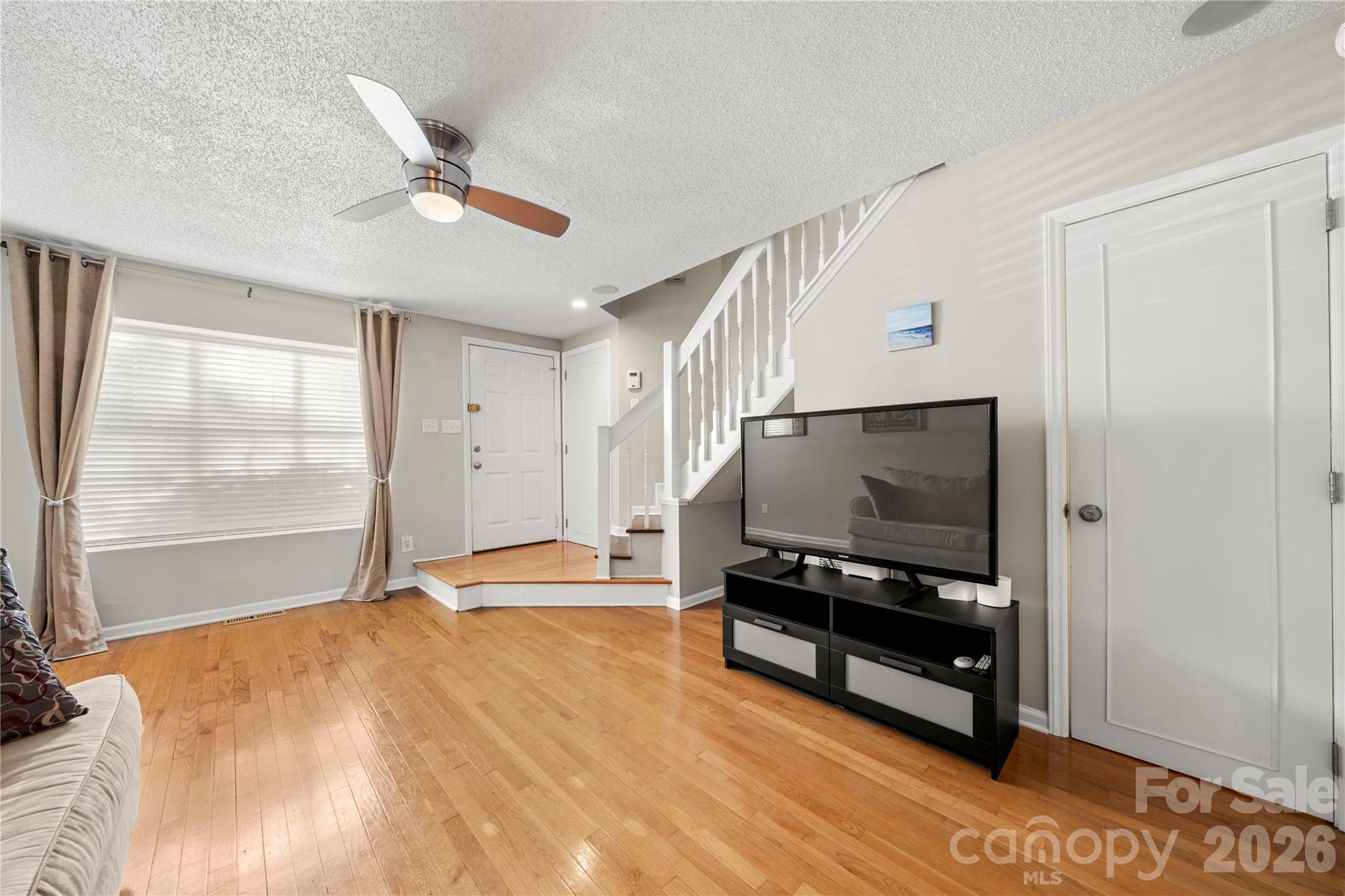 8240 Circle Tree Lane Charlotte, NC 28277 - Photo 6 of 29 a living room with furniture and a flat screen tv