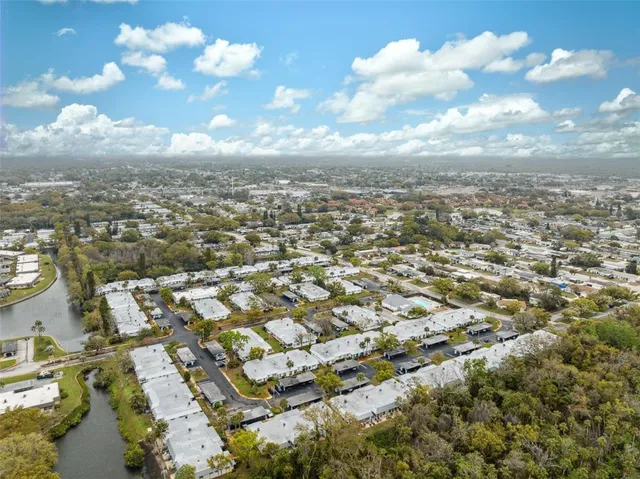an aerial view of residential building with yard