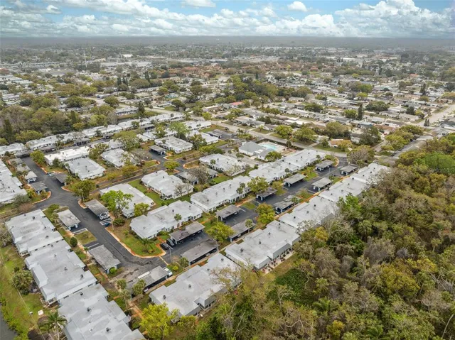 an aerial view of residential houses with outdoor space