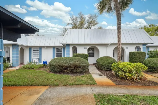 a front view of a house with garden and porch