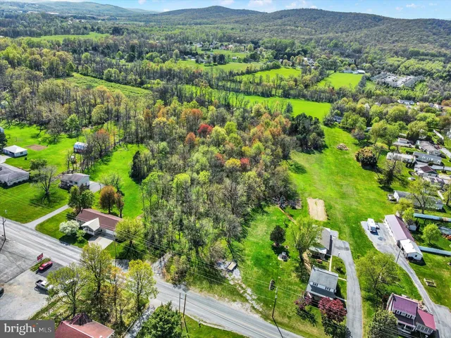an aerial view of a houses with a yard
