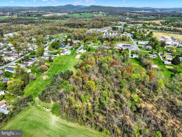 an aerial view of residential houses with outdoor space and covered