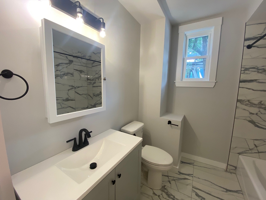 120 Marginal Street, Unit 1 Boston, MA 02128 - Photo 16 of 18 a bathroom with a sink mirror and toilet