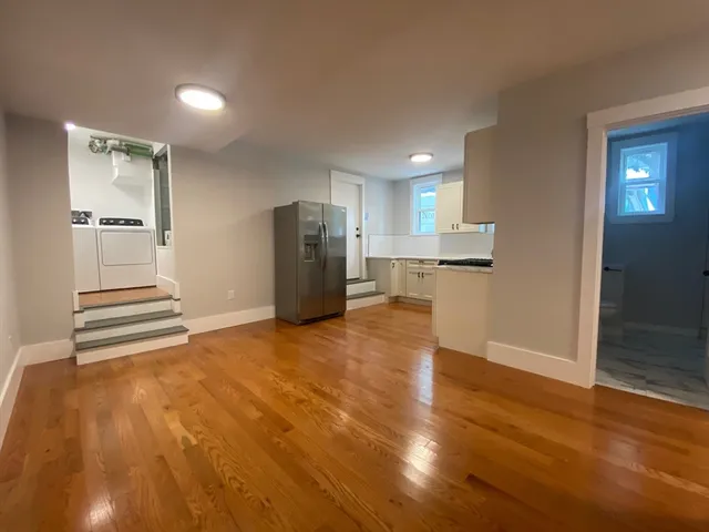 a view of a kitchen with a sink and a refrigerator